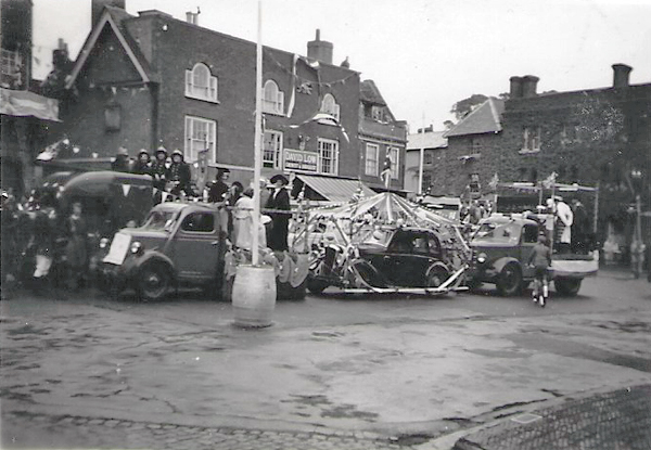 Decorated floats in the Market Square, rain